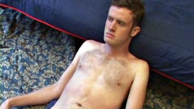 Nate Ritchie strips naked and strokes his cock to the top while his eyes are glued to the porn video being played. He strokes lying down and standing up, before finally deciding that the best way to cum is on his stomach.