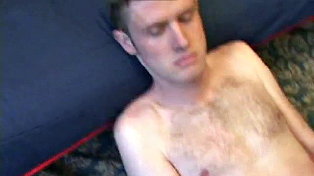 Nate Ritchie strips naked and strokes his cock to the top while his eyes are glued to the porn video being played. He strokes lying down and standing up, before finally deciding that the best way to cum is on his stomach.