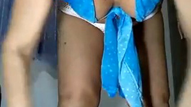 Naughty slut Mirella Delicia dancing in white beach shorts and blue blouse wiggling while doing a striptease