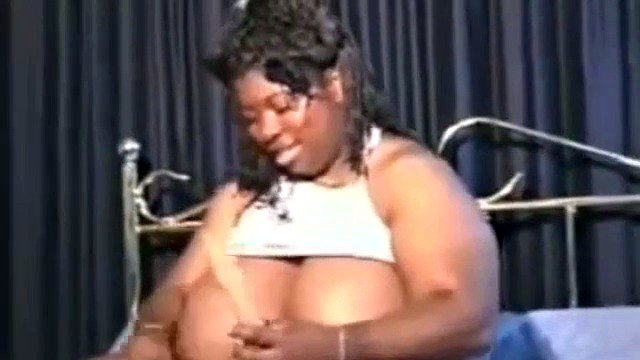 Big smiling ebony SSBBW with giant breasts has fun with toys