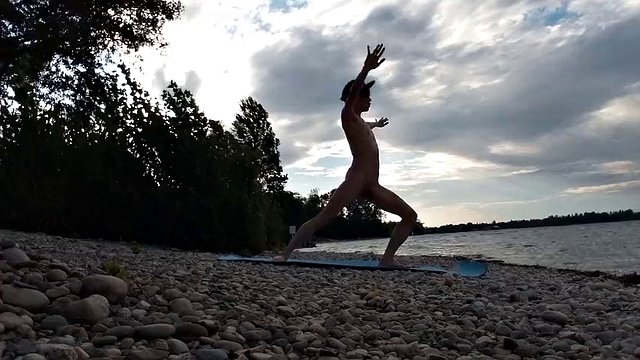 Slim nudist boy doing yoga naked on a nudist beach. Nude yoga video by John Artin, gay porn model, skinny naturist, twink, practice