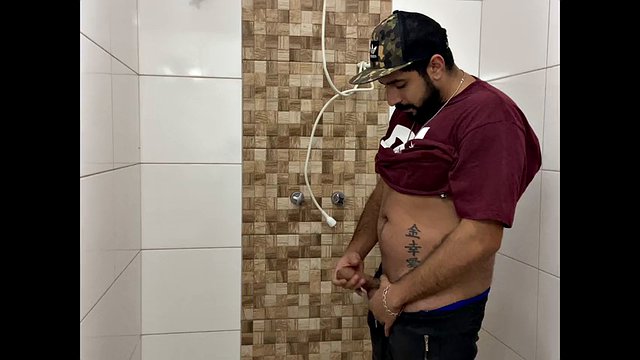 Squirting cum, bearded man with a cap alone in the bathroom having fun in the handjob until he cums a lot - Rodrik Dick