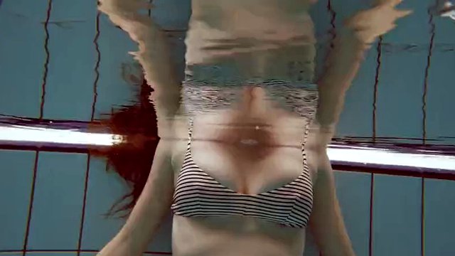 Big tits Lola gets naked in the pool for you