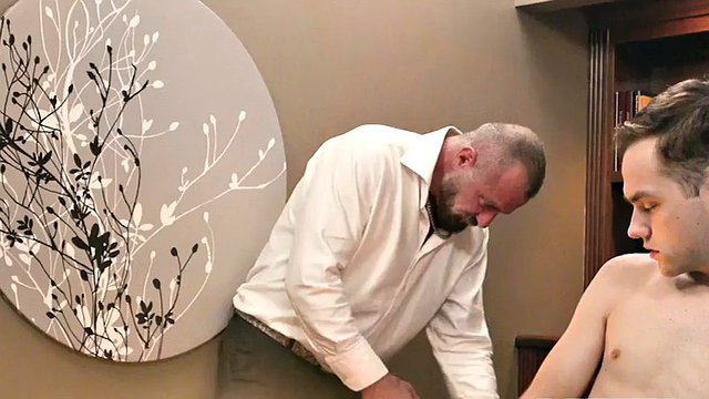 Petite twink plays with his ass with help from DILF's HJ in the office